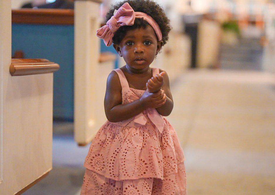 A toddler clapping in the sanctuary